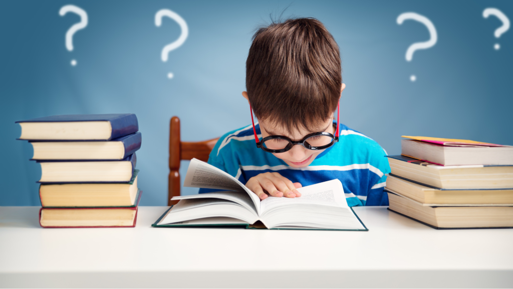 Young boy with glasses reading a book. Representing autism and memory